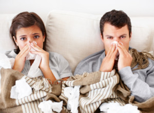 Portrait of a young couple suffering from the flu together